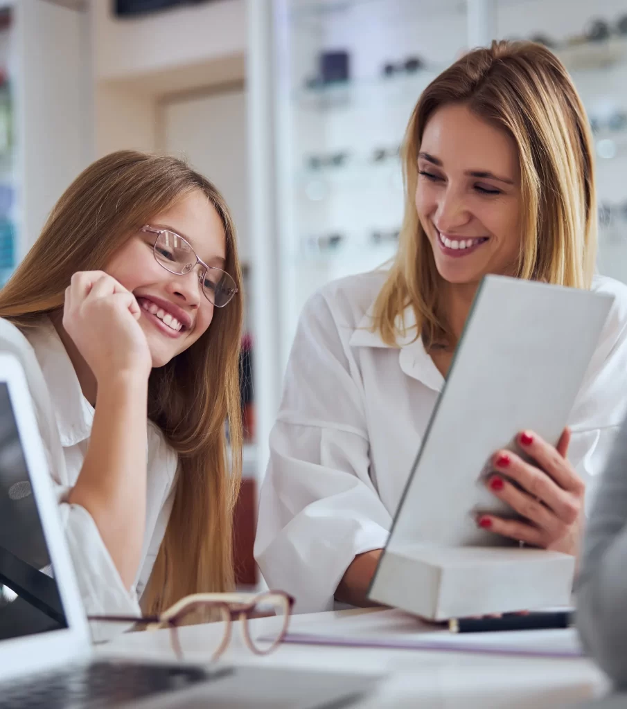 A trained professional with a young patient elios optical